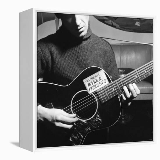 Folk Singer Woody Guthrie Playing Guitar with Sign on It Reading This Machine Kills Fascists-Eric Schaal-Framed Premier Image Canvas