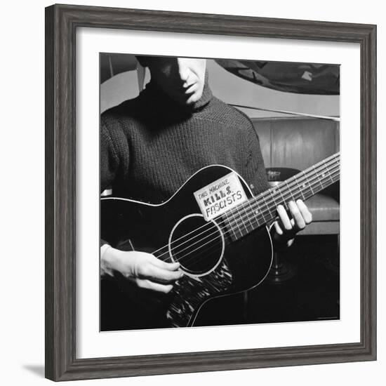 Folk Singer Woody Guthrie Playing Guitar with Sign on It Reading This Machine Kills Fascists-Eric Schaal-Framed Premium Photographic Print