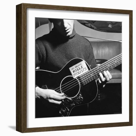 Folk Singer Woody Guthrie Playing Guitar with Sign on It Reading This Machine Kills Fascists-Eric Schaal-Framed Premium Photographic Print