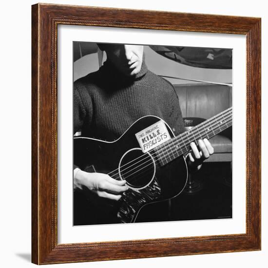 Folk Singer Woody Guthrie Playing Guitar with Sign on It Reading This Machine Kills Fascists-Eric Schaal-Framed Premium Photographic Print