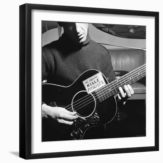 Folk Singer Woody Guthrie Playing Guitar with Sign on It Reading This Machine Kills Fascists-Eric Schaal-Framed Premium Photographic Print