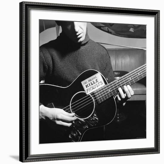 Folk Singer Woody Guthrie Playing Guitar with Sign on It Reading This Machine Kills Fascists-Eric Schaal-Framed Premium Photographic Print