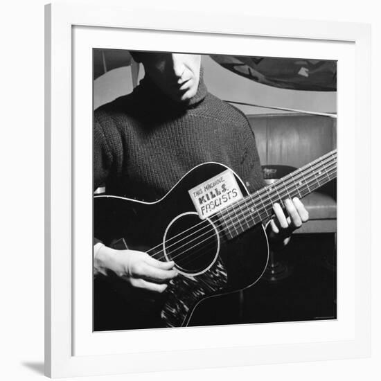 Folk Singer Woody Guthrie Playing Guitar with Sign on It Reading This Machine Kills Fascists-Eric Schaal-Framed Premium Photographic Print
