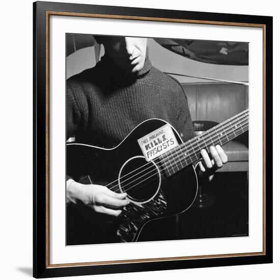 Folk Singer Woody Guthrie Playing Guitar with Sign on It Reading This Machine Kills Fascists-Eric Schaal-Framed Premium Photographic Print