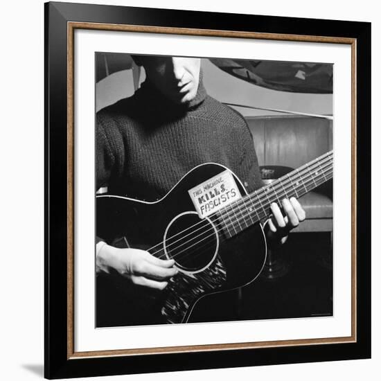 Folk Singer Woody Guthrie Playing Guitar with Sign on It Reading This Machine Kills Fascists-Eric Schaal-Framed Premium Photographic Print