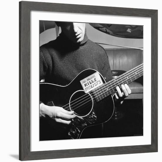 Folk Singer Woody Guthrie Playing Guitar with Sign on It Reading This Machine Kills Fascists-Eric Schaal-Framed Premium Photographic Print