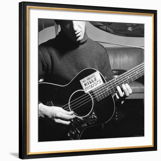 Folk Singer Woody Guthrie Playing Guitar with Sign on It Reading This Machine Kills Fascists-Eric Schaal-Framed Premium Photographic Print