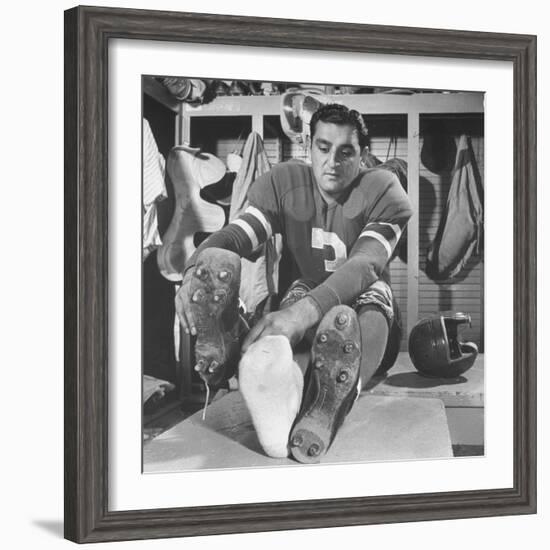 Football Player Ben Agajanian Putting on Football Cleats-Allan Grant-Framed Premium Photographic Print