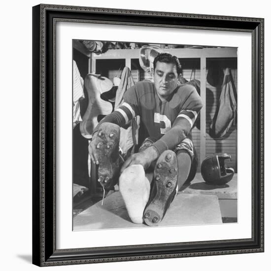 Football Player Ben Agajanian Putting on Football Cleats-Allan Grant-Framed Premium Photographic Print