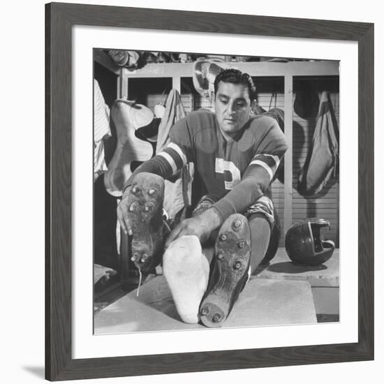 Football Player Ben Agajanian Putting on Football Cleats-Allan Grant-Framed Premium Photographic Print