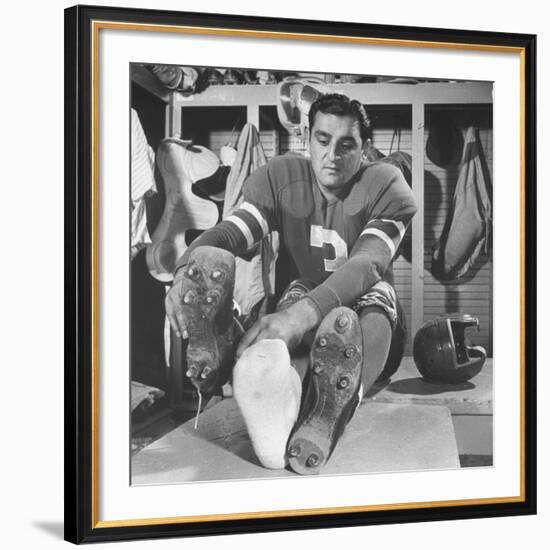 Football Player Ben Agajanian Putting on Football Cleats-Allan Grant-Framed Premium Photographic Print