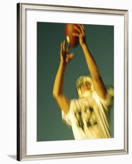 Football Player Reaching Up To Catch a Ball-null-Framed Photographic Print