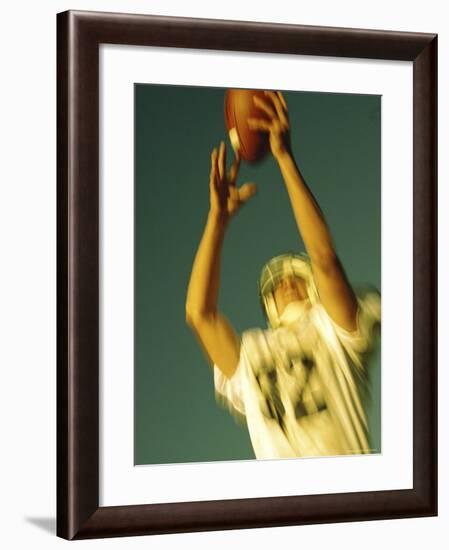 Football Player Reaching Up To Catch a Ball-null-Framed Photographic Print