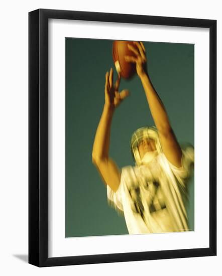 Football Player Reaching Up To Catch a Ball-null-Framed Photographic Print