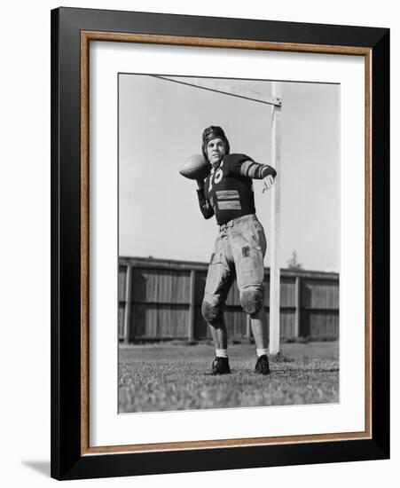 Football Player Throwing Ball-null-Framed Photo