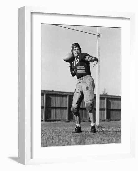 Football Player Throwing Ball-null-Framed Photo