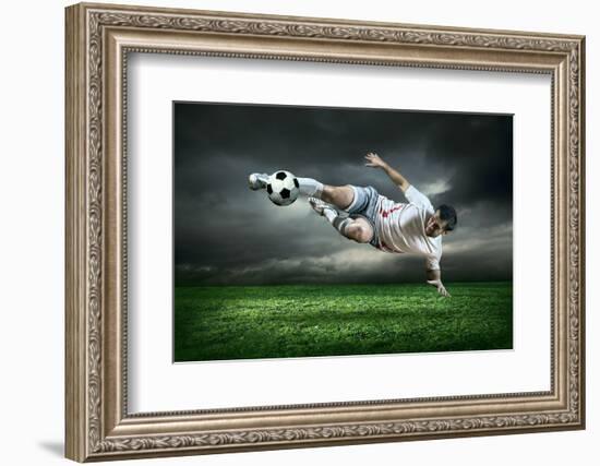 Football Player with Ball in Action Outdoors-Andrey Yurlov-Framed Photographic Print