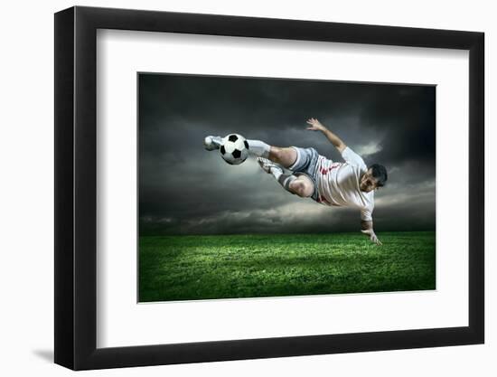 Football Player with Ball in Action Outdoors-Andrey Yurlov-Framed Photographic Print