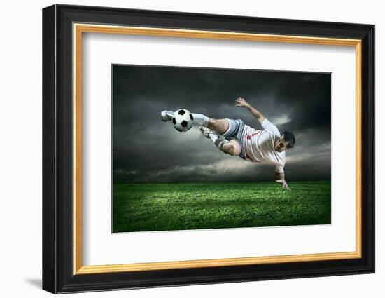 Football Player with Ball in Action Outdoors-Andrey Yurlov-Framed Photographic Print