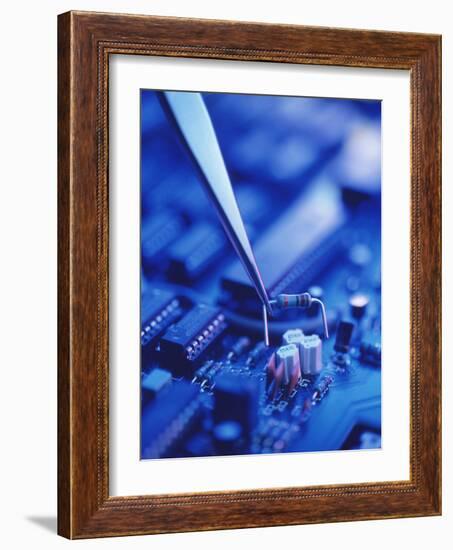 Forceps Holding a Resistor Over a Circuit Board-Chris Knapton-Framed Photographic Print