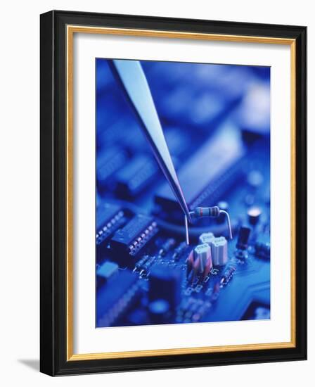 Forceps Holding a Resistor Over a Circuit Board-Chris Knapton-Framed Photographic Print