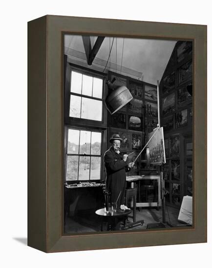 Former PM Winston Churchill Smoking a Cigar in His Studio Dressed in His Blue RAF Siren Jump Suit-Hans Wild-Framed Premier Image Canvas