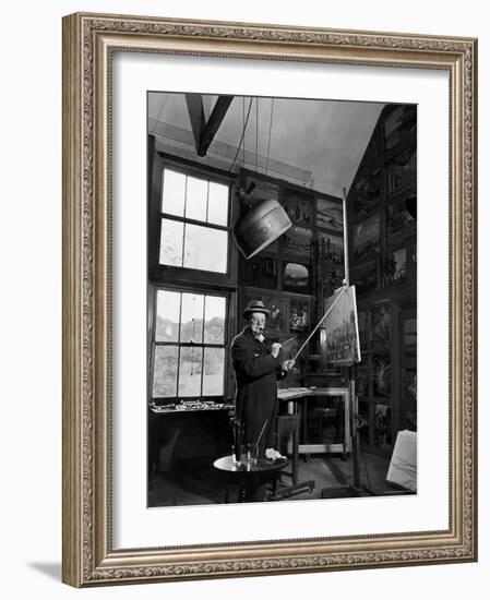 Former PM Winston Churchill Smoking a Cigar in His Studio Dressed in His Blue RAF Siren Jump Suit-Hans Wild-Framed Photographic Print