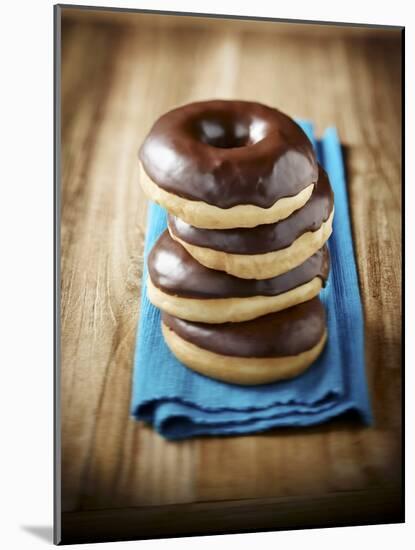 Four Doughnuts with Chocolate Glaze, Stacked-Michael Löffler-Mounted Photographic Print