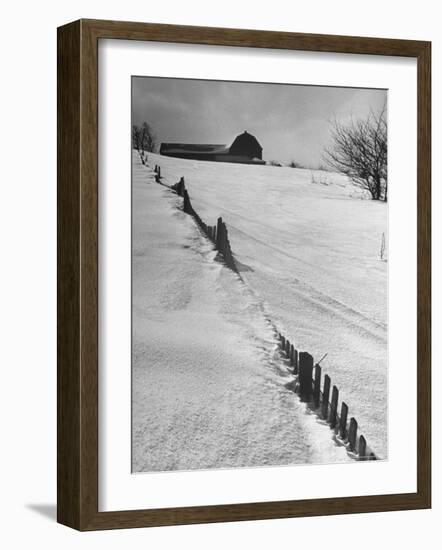 Four Ft. of Snow Almost Covering Up Snow Fence in Front of Barn on the Hill on Upstate Farm-Andreas Feininger-Framed Photographic Print