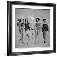 Four Models Showing Off the Latest Bathing Suit Fashions While Lying on a Sandy Florida Beach-Nina Leen-Framed Photographic Print