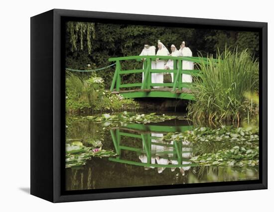 Four Nuns Standing on the Japanese Bridge in the Garden of the Impressionist Painter Claude Monet-David Hughes-Framed Premier Image Canvas