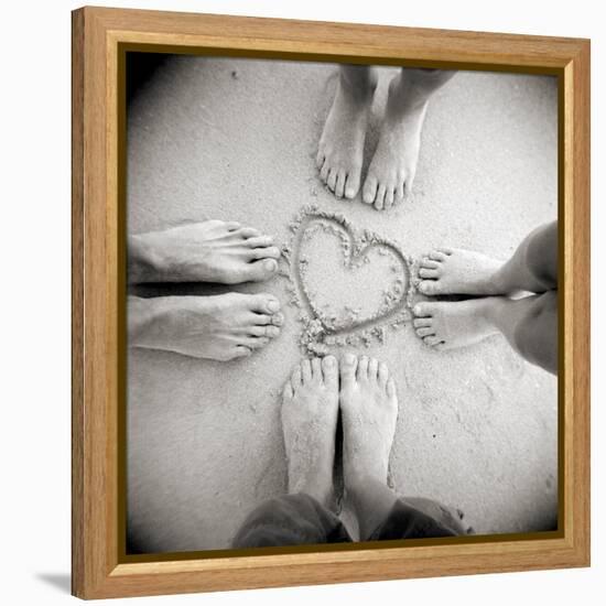 Four Pairs of Feet Standing around a Heart Shape Drawn in Sandy Beach, Taransay, Scotand, UK-Lee Frost-Framed Premier Image Canvas