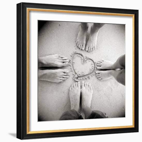 Four Pairs of Feet Standing around a Heart Shape Drawn in Sandy Beach, Taransay, Scotand, UK-Lee Frost-Framed Photographic Print