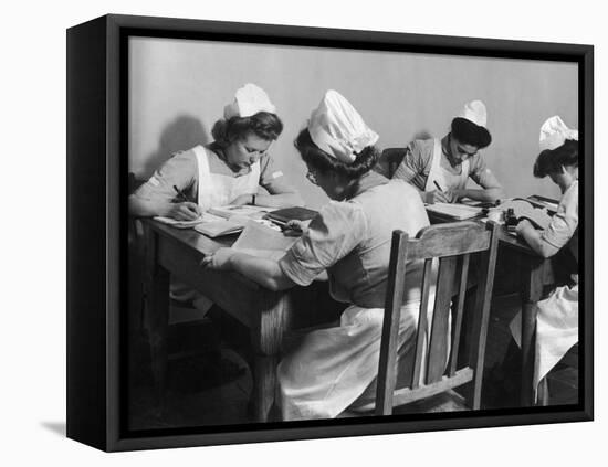Four Young British Student Nurses Making Notes Together from Medical Textbooks-null-Framed Premier Image Canvas