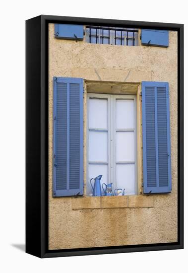 France, Provence, Lourmarin. Blue Shutters Frame a Scene of Blue Pitchers on a Windowsill-Brenda Tharp-Framed Premier Image Canvas