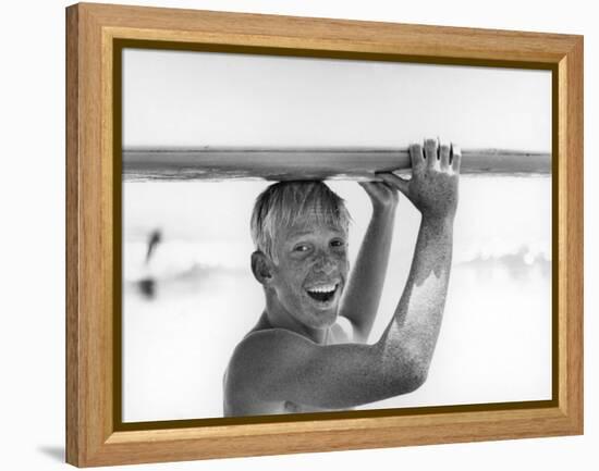 Freckled Surfer Larry Shaw Carrying Surfboard on His Head-Allan Grant-Framed Premier Image Canvas