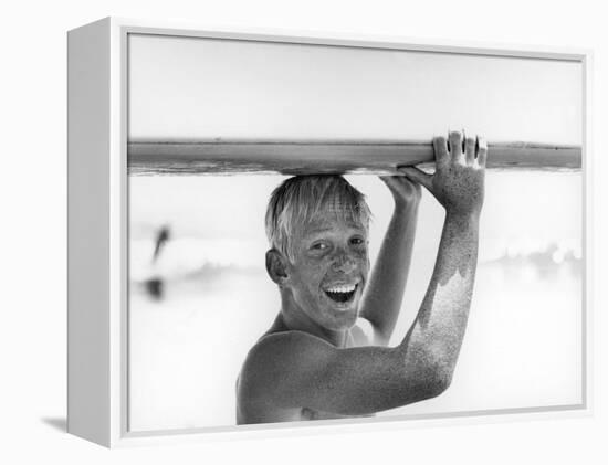 Freckled Surfer Larry Shaw Carrying Surfboard on His Head-Allan Grant-Framed Premier Image Canvas