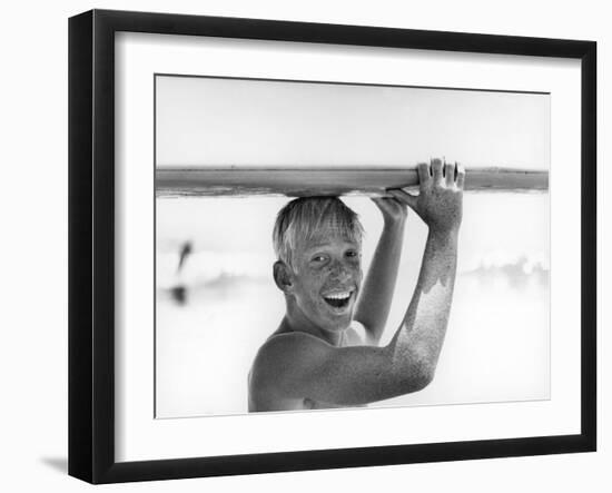 Freckled Surfer Larry Shaw Carrying Surfboard on His Head-Allan Grant-Framed Photographic Print