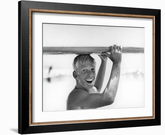 Freckled Surfer Larry Shaw Carrying Surfboard on His Head-Allan Grant-Framed Photographic Print