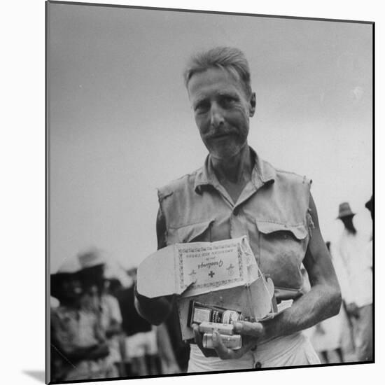 Freed American Pow Holding Red Cross Supplies after His Release from a Japanese Prison Camp-Carl Mydans-Mounted Photographic Print