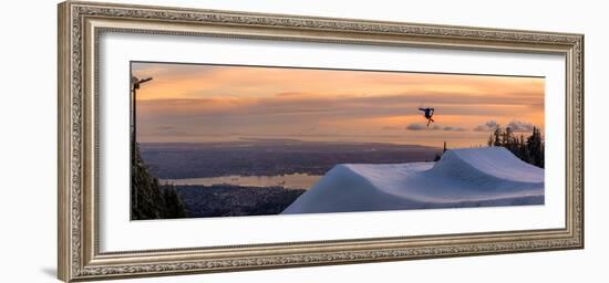 Freestyle skier doing a trick off a jump above city at sunset, Canada, North America-Tyler Lillico-Framed Photographic Print