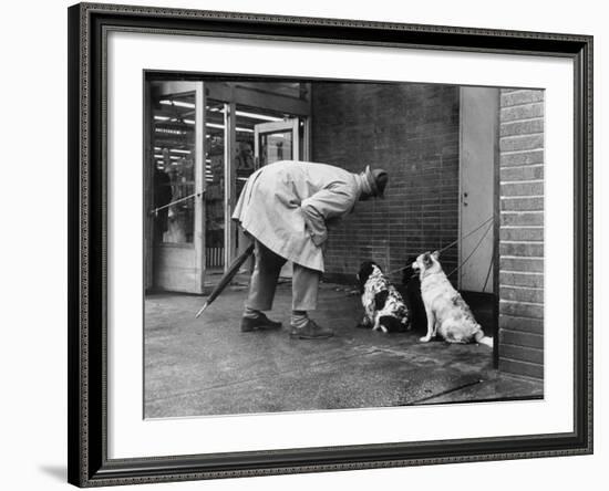 French Actor Jacques Tati Talking to a Couple of Dogs-Yale Joel-Framed Premium Photographic Print