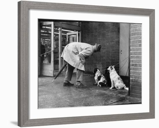 French Actor Jacques Tati Talking to a Couple of Dogs-Yale Joel-Framed Premium Photographic Print