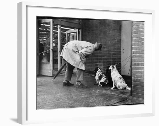 French Actor Jacques Tati Talking to a Couple of Dogs-Yale Joel-Framed Premium Photographic Print