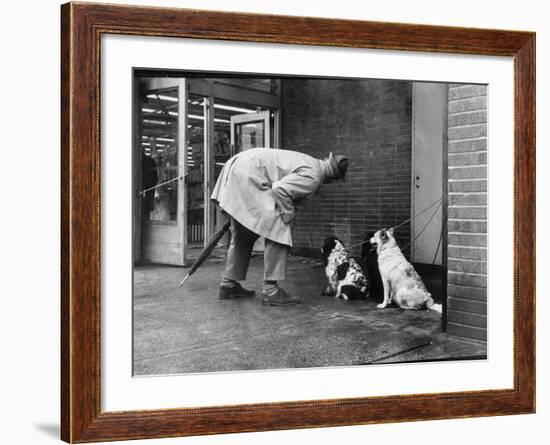 French Actor Jacques Tati Talking to a Couple of Dogs-Yale Joel-Framed Premium Photographic Print