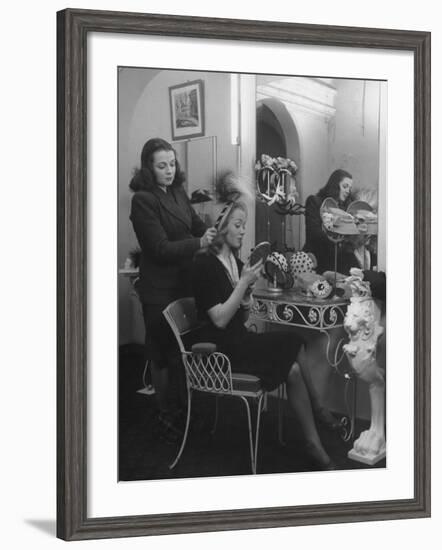 French Actress Barbara Laage Trying on a Hat in Shop Where Her Sister Works-null-Framed Photographic Print