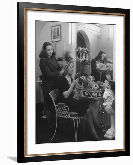 French Actress Barbara Laage Trying on a Hat in Shop Where Her Sister Works-null-Framed Photographic Print