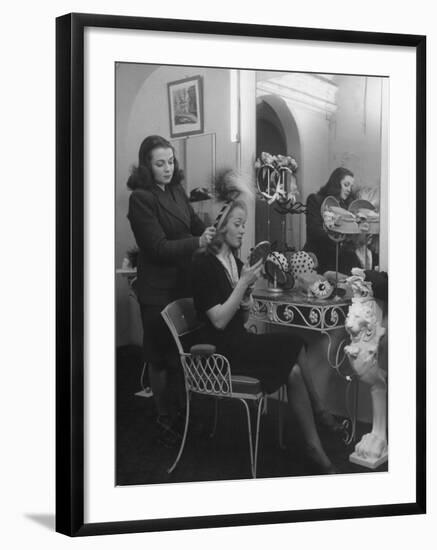 French Actress Barbara Laage Trying on a Hat in Shop Where Her Sister Works-null-Framed Photographic Print