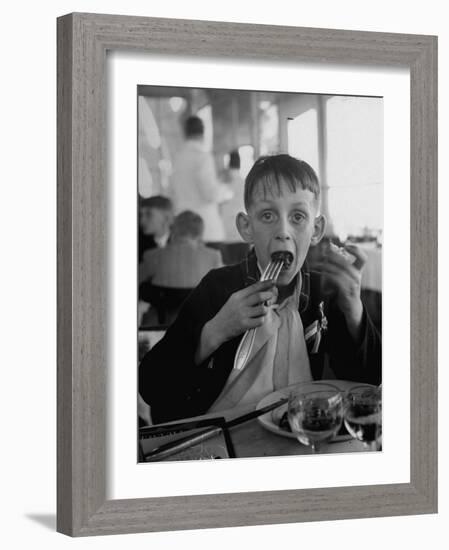 French Boy Andre Poindeeault Mastering a Big Bite-Nat Farbman-Framed Photographic Print