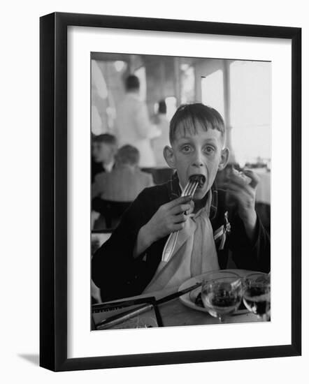 French Boy Andre Poindeeault Mastering a Big Bite-Nat Farbman-Framed Photographic Print